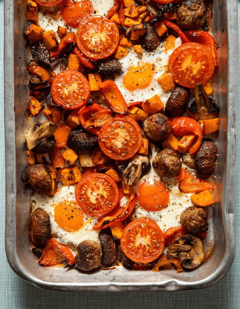 A Breakfast traybake inspired by the Hairy Dieters—a sheet pan filled with baked eggs, tomatoes, mushrooms, potatoes, and red bell peppers. Simple healthy food that's seasoned and perfectly roasted for a delicious start to your day.
