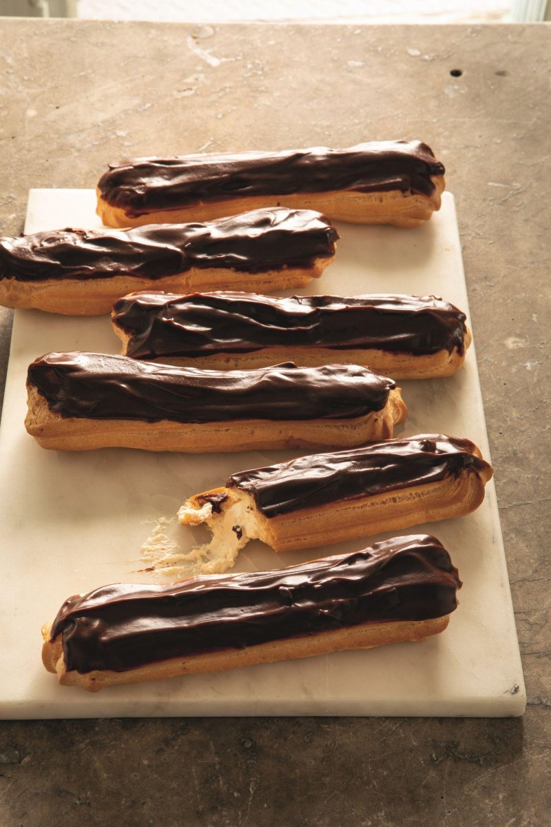 A tray of luxurious chocolate eclairs.